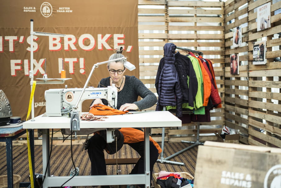 Photo of a woman sitting behind a sewing machine