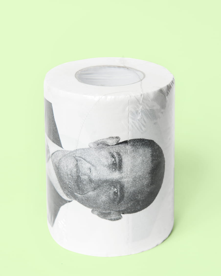 Photo of a roll of toilet paper with a picture of Obama on it - on a green background