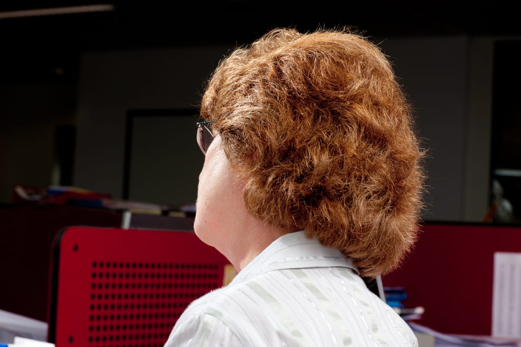 Photo of the back of the head of a woman with red hair