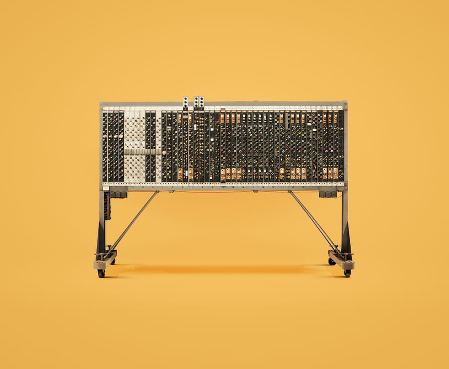 Photo of an old computer against a yellow background