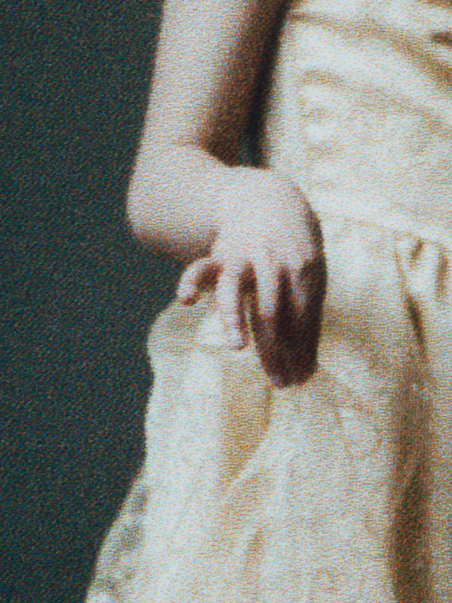 Close up photo of a girl holding her dress with her pinkie up