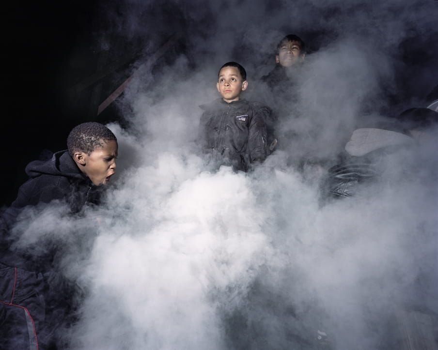 Photo of three kids playing with smoke