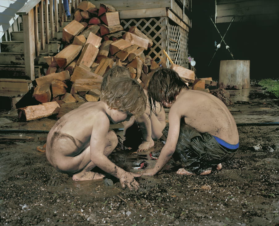 Photo of boys playing in the mud