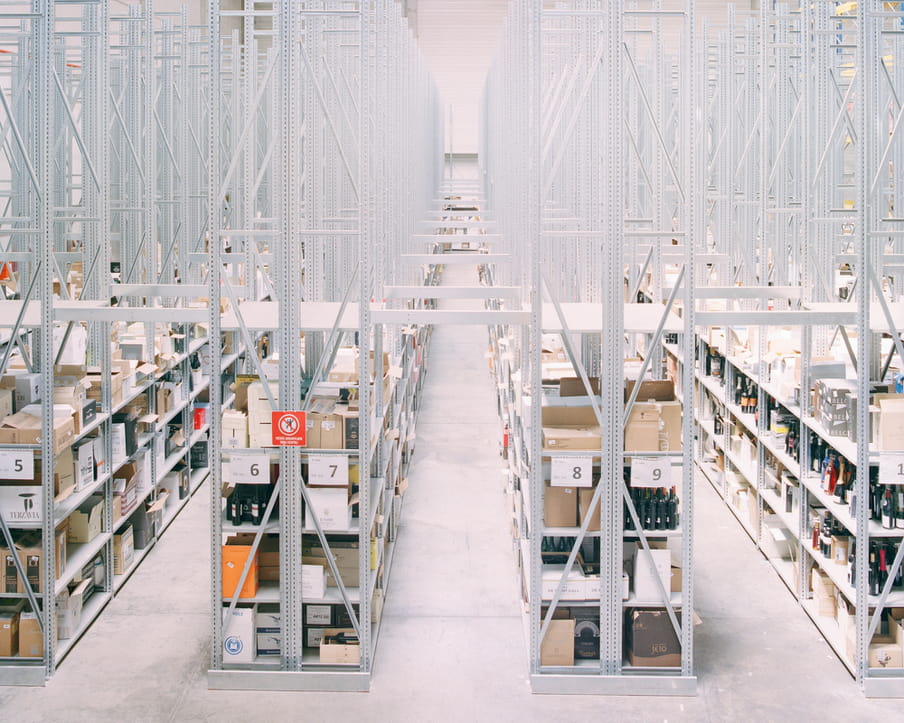 Colour photograph of a warehouse showing shelves and boxes. 