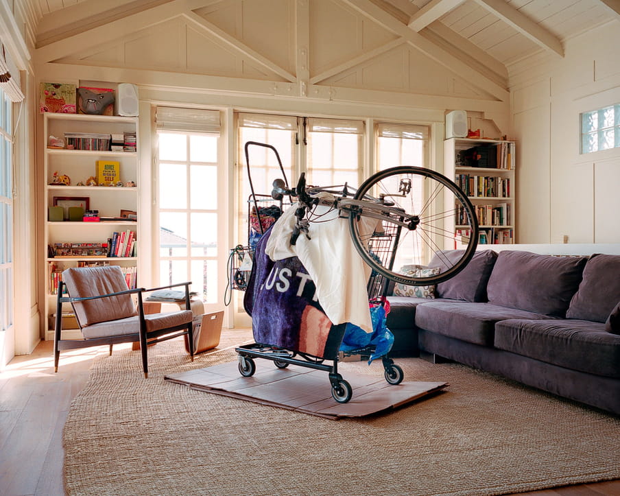 Photo of a living room of a middle or upper class house, with parts that could make up a homeless shelter in it