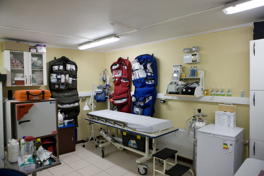 Medical room with a hospital bed and some medicine and equipment.