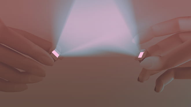 Faded brown and greyish illustration of two hands holding a small box towards each other, shining a light pink light.