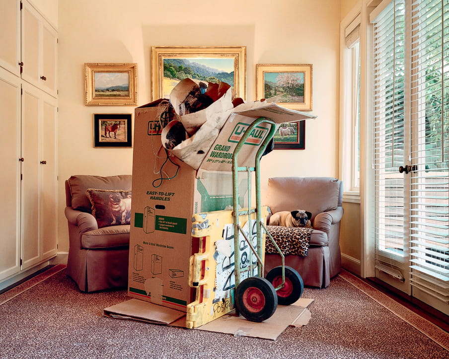 Photo of a living room of a middle or upper class house, with the parts of a homeless shelter in it