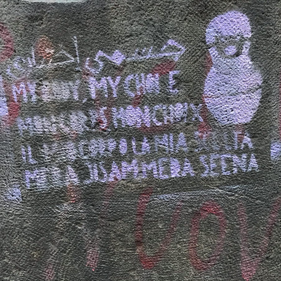 A stencil that says "My body my choice" in several languages, with the image of a Russian doll next to it.