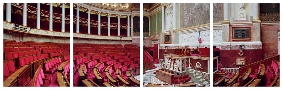 Photograph of a large hall with many red chairs