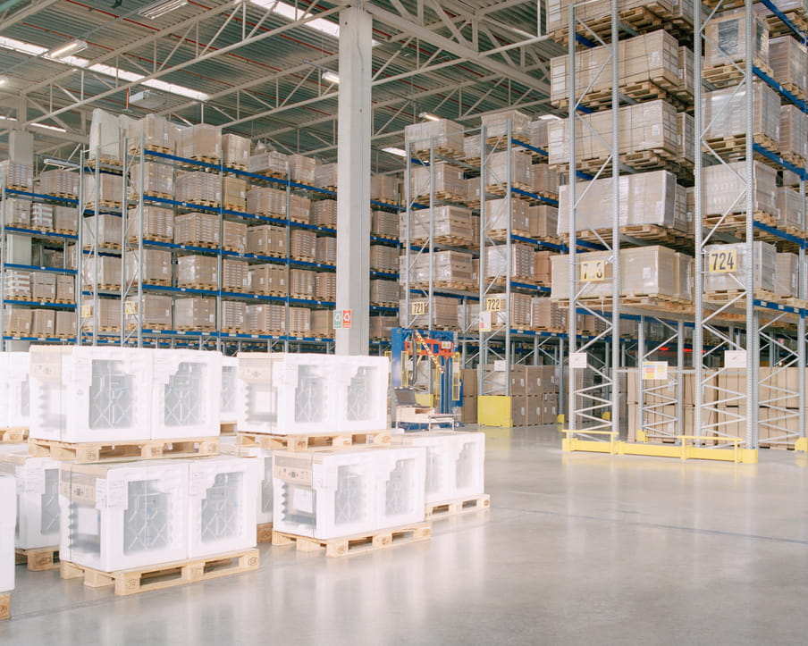 Colour photograph of a warehouse showing boxes and shelves. 