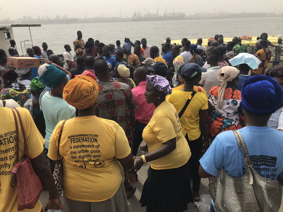 Several members of the Nigerian Slum/Information Settlement Federation who have been evicted from their homes in Tarkwa Bay stand on the CMS jetty.