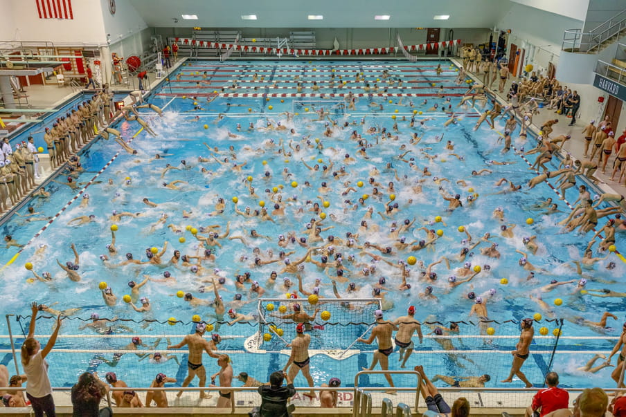 Photo-montage of a water polo game, heavily crowded with men playing.