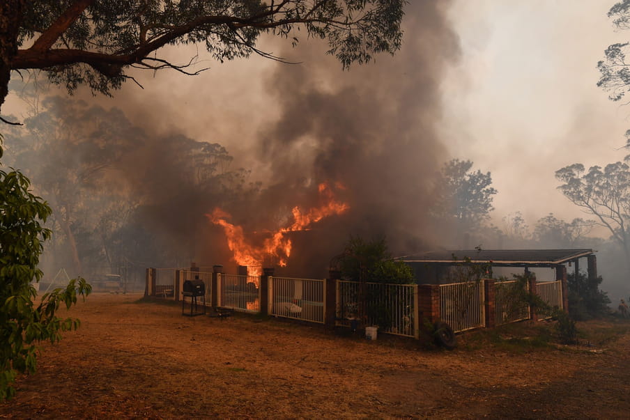 A house burns on a property in Buxton, New South Wales, 19 December 2019. Temperatures above 40 degrees Celsius and strong winds are fanning a a number of fires around Sydney.