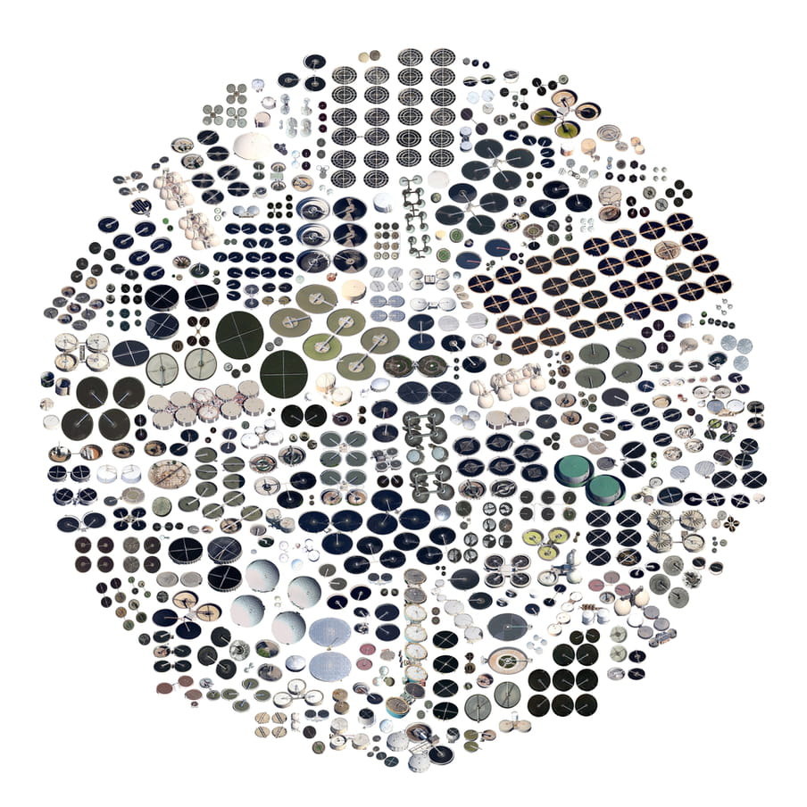 Circle shaped image, on a white background, composed of various tiny circular shapes in white, grey, black and green shades.