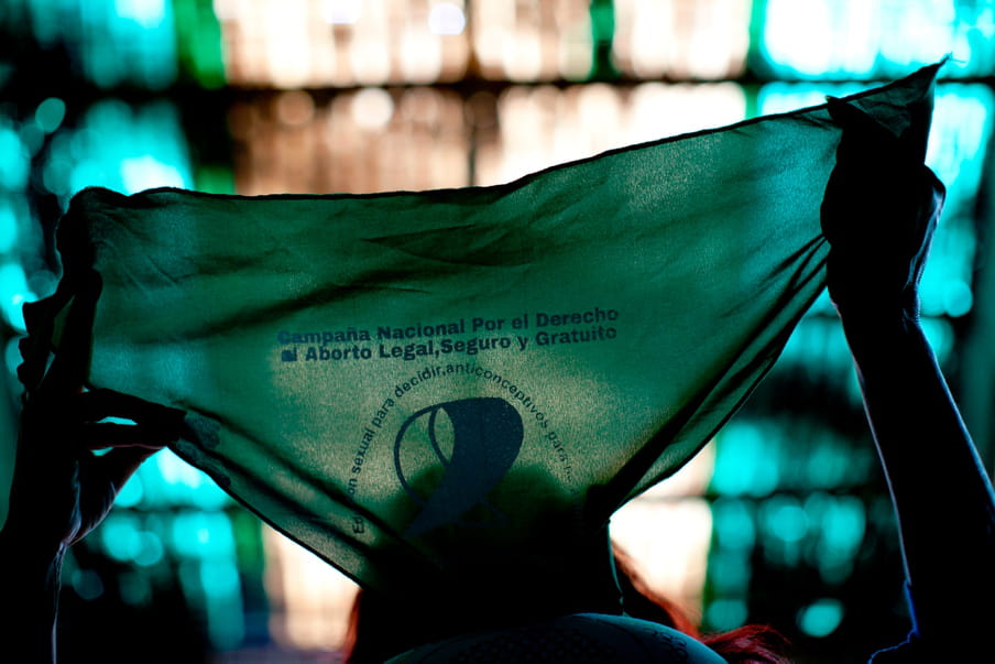 Photo of a person holding a green bandana up with backlight