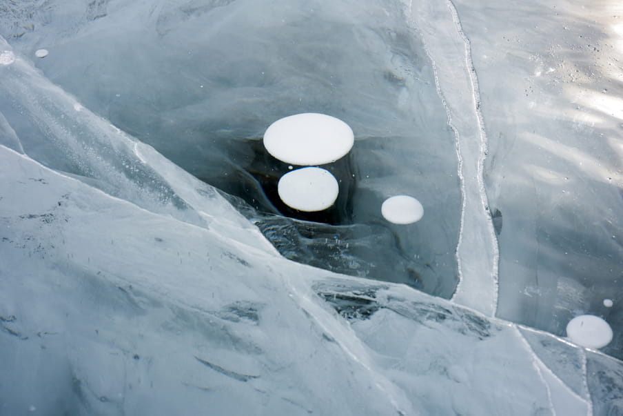 Image showing white cloud looking shapes and other white circles and lines on a dark blue back ground.