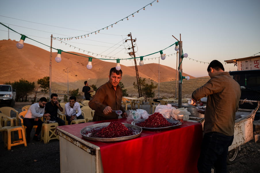 Photograph of a man distributing food to people