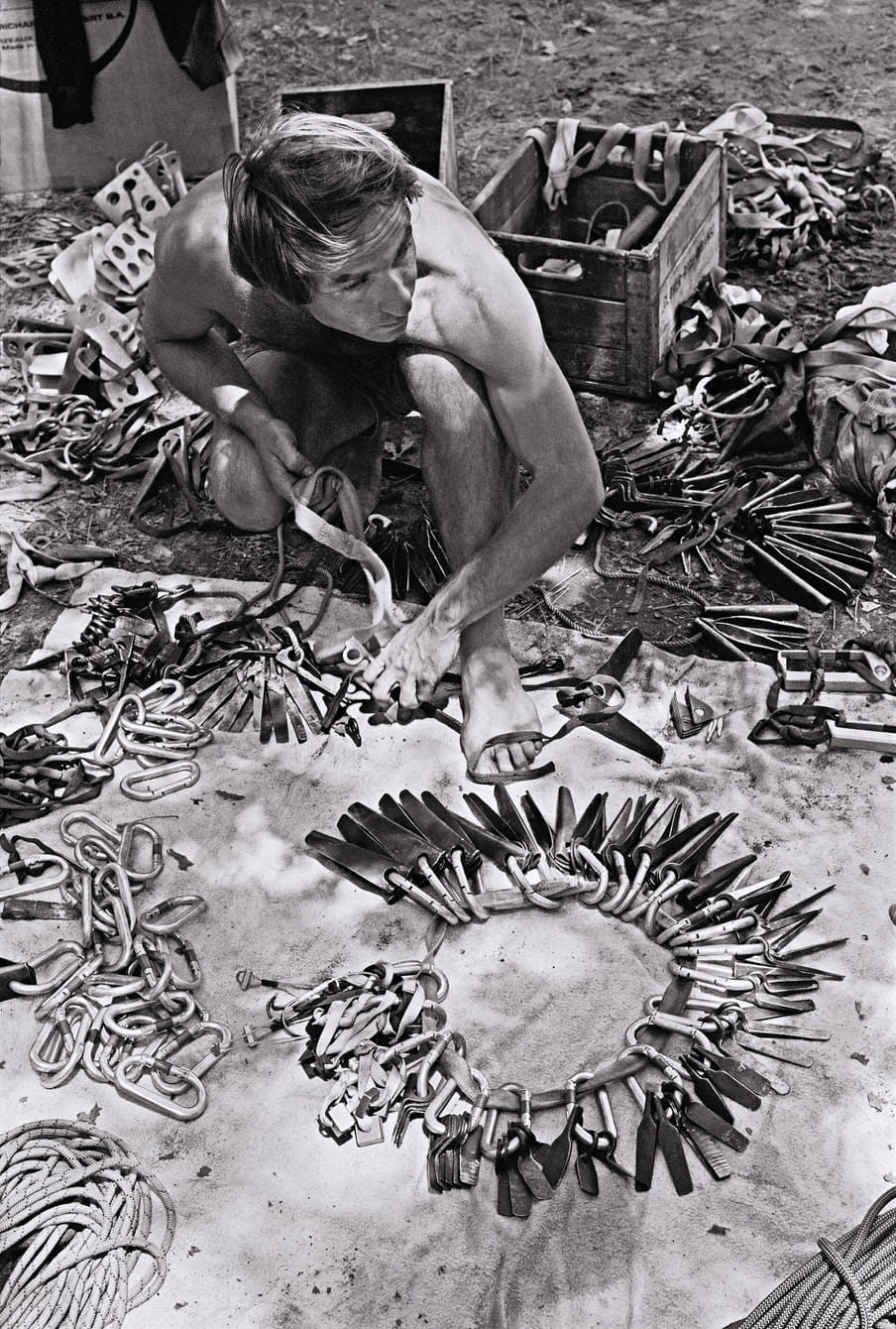 Black and white photo of man working on wooden tools