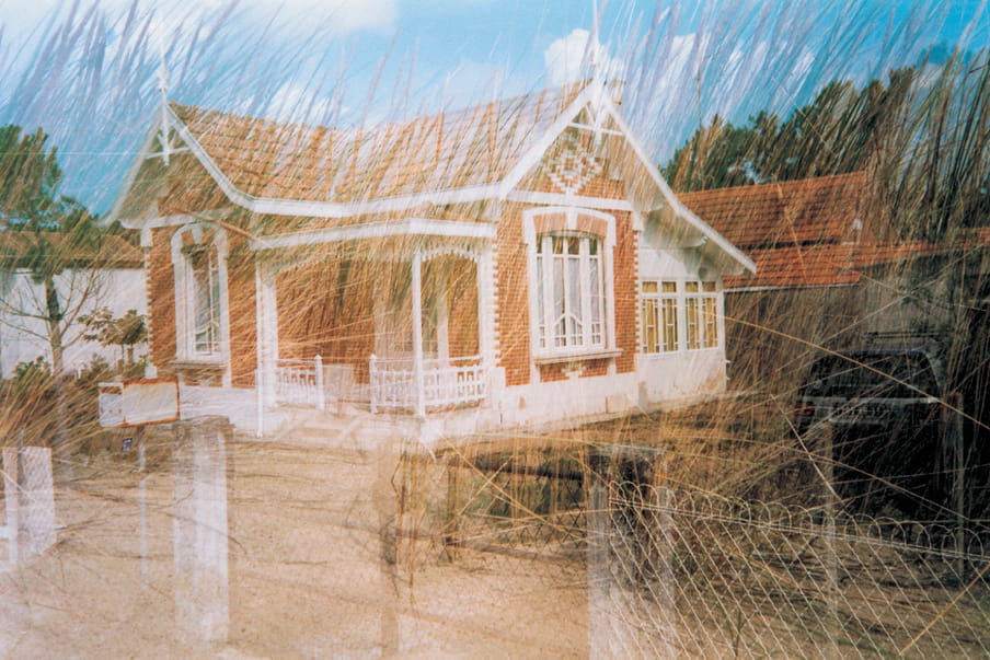 Double exposure photograph - of a house and a field of grass, overlapping.