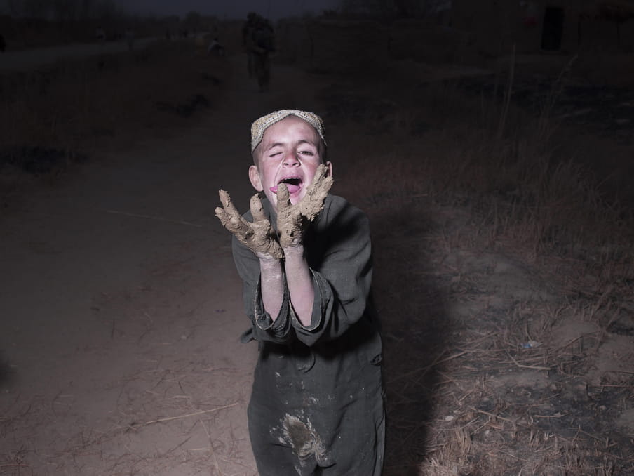 Photo of a kids playing with mud.