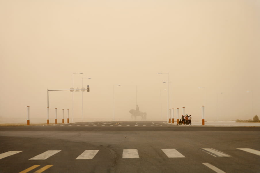 An almost deserted street with a foggy background. 