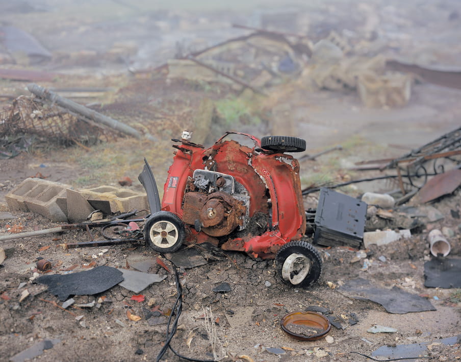 Photo of a lawnmower, destroyed and in pieces