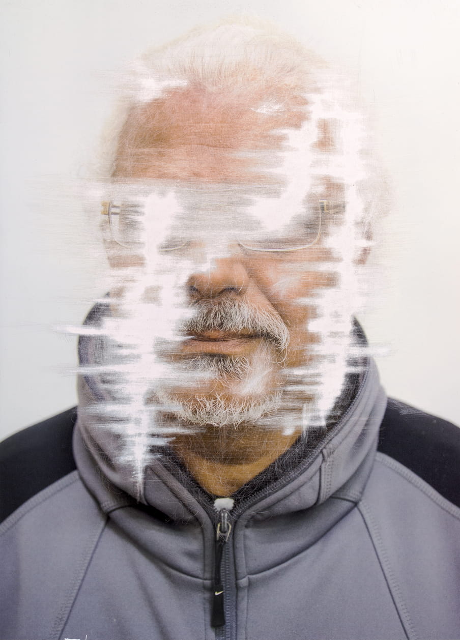 Scratched colour portrait of a man, in which her face is unrecognisable.