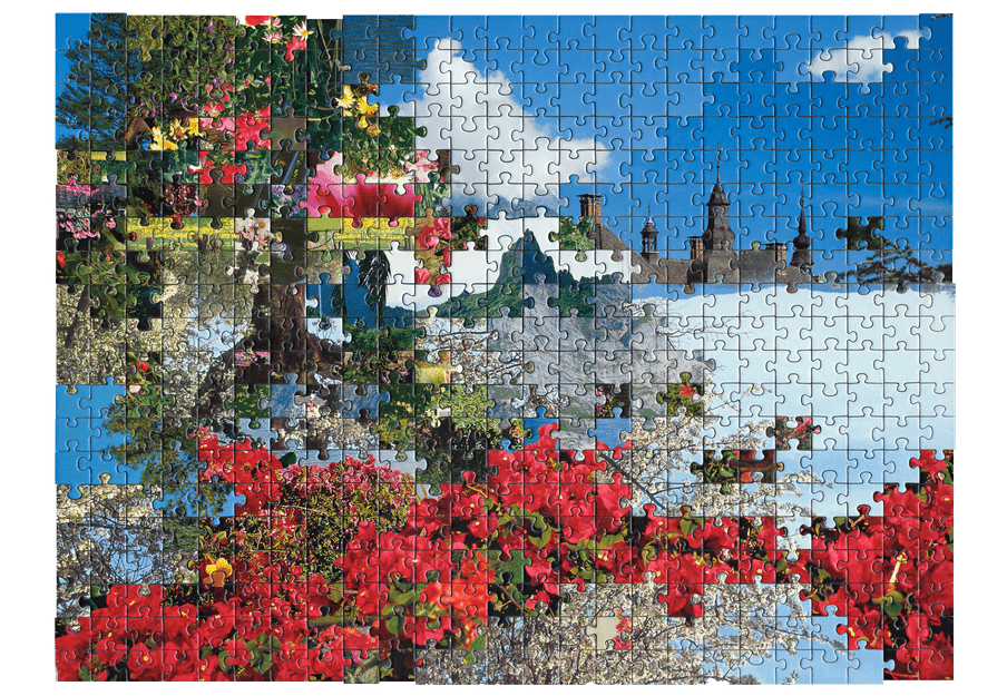 Photo of a puzzle, combining pieces from different types of images together to create new landscape. Here a flowery landscape is combined with a picture of a castle.