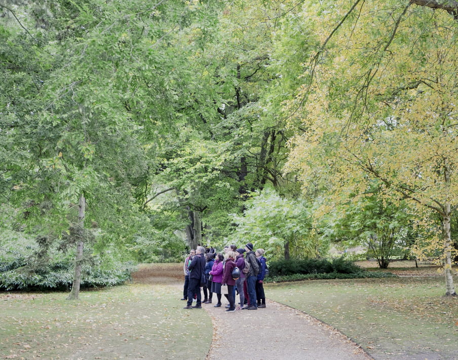 Group of people standing close together in a park