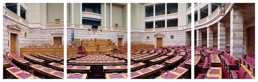 Photograph of a large hall with many red chairs