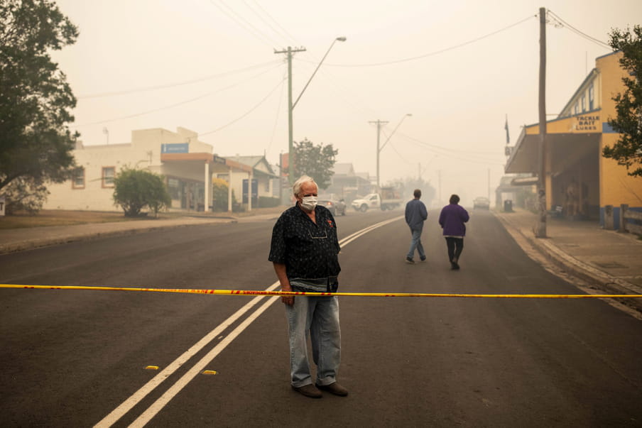 A Cobargo resident looks at destroyed buildings in Cobargo, New South Wales, Australia, 01 January 2020.