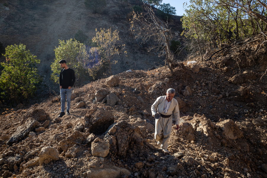 Photograph of two men on a hill