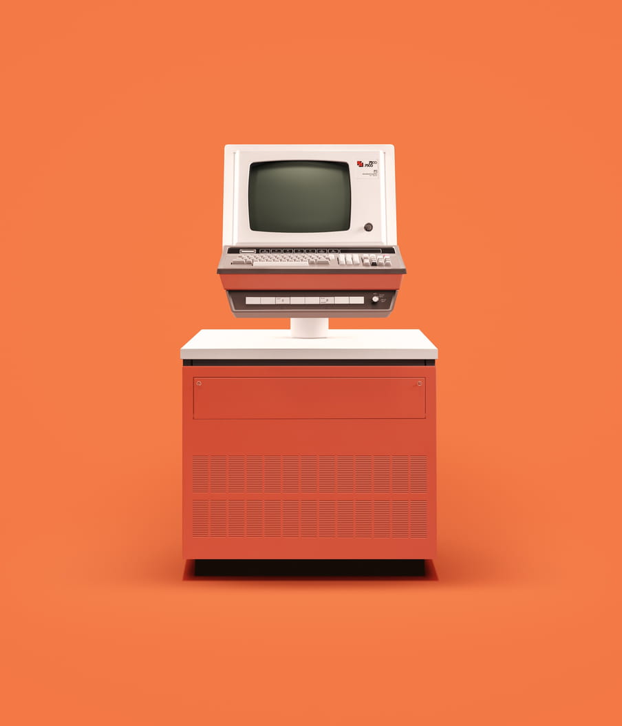 Photo of an old computer against an orange background