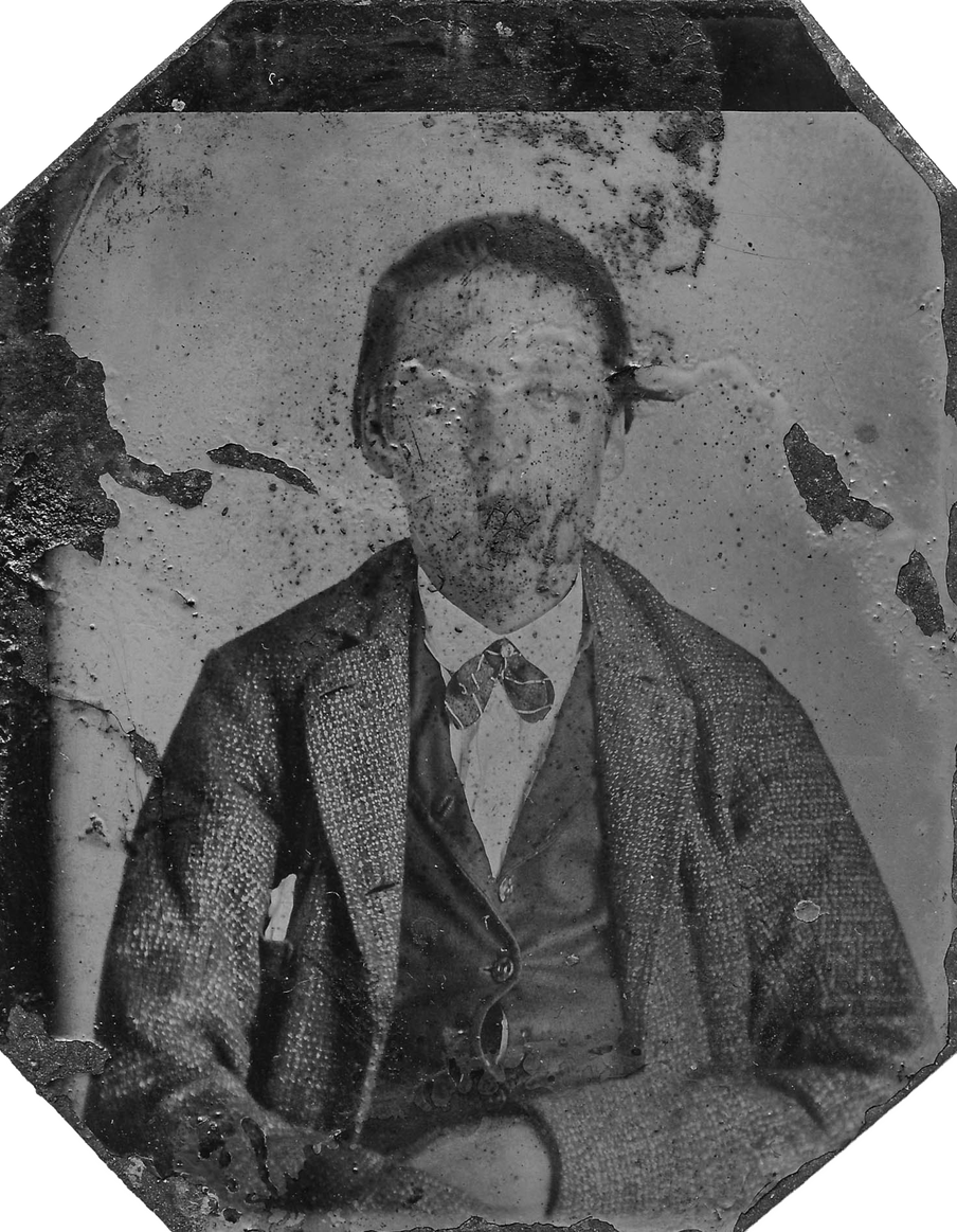 Old damaged photograph of a man, his face barely recognisable because of the damage