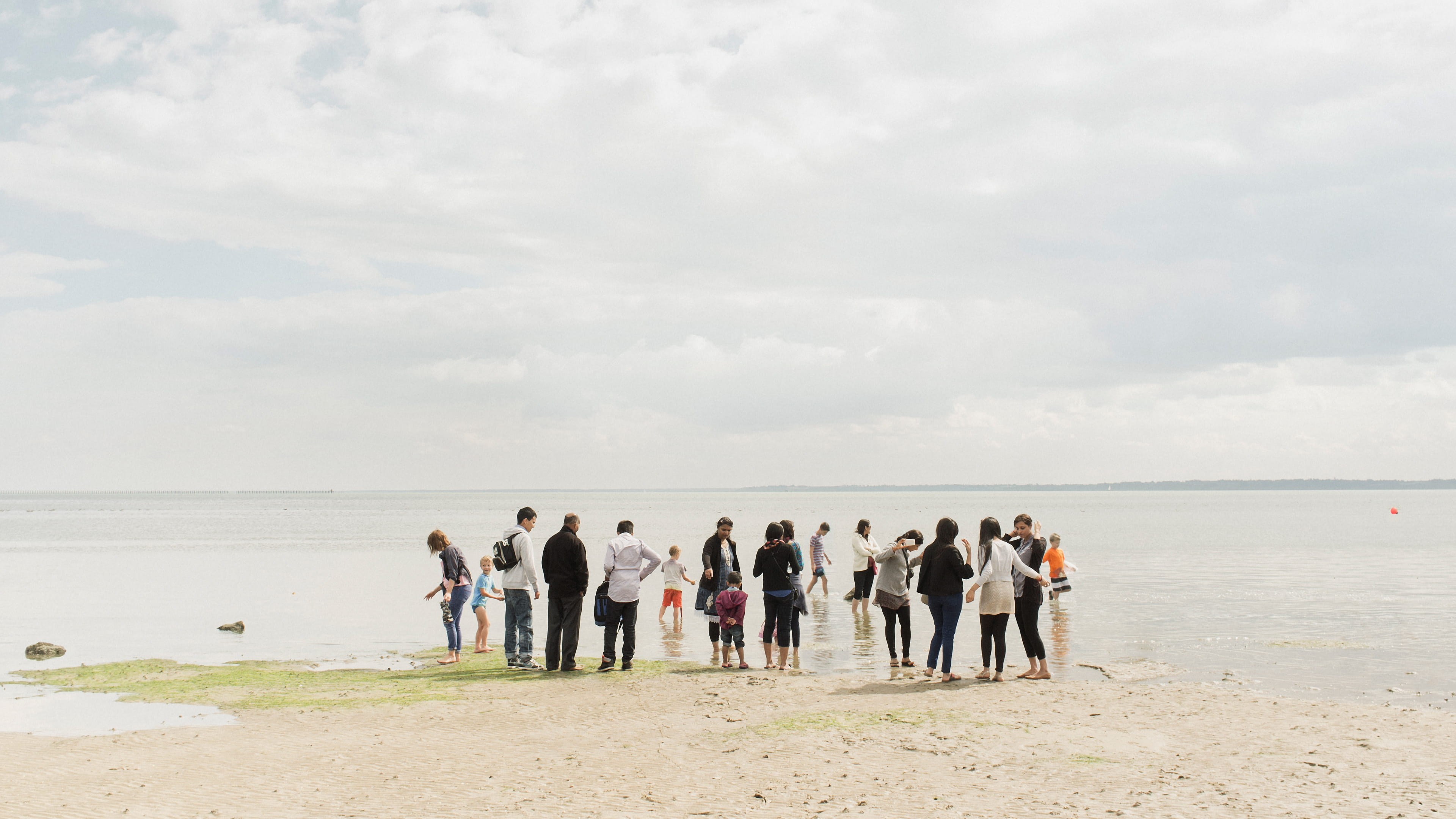 Photo of a group of people standing on a beach