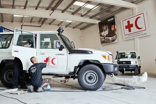 Land Rovers being prepped for the field in the IFRC garage in Dubai.  Pieter van den Boogert for The Correspondent