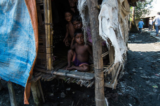 A mother with her two children in Aung Mingalar. Photo by Andreas Staahl