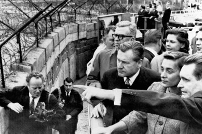 Nelson Rockefeller and his wife view sights on the east side of the Berlin Wall as pointed out by a West German guide. Photo by Hollandse Hoogte