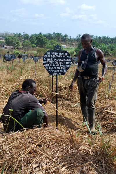 Mariama Jalloh searches for her father’s grave in Bo. The gravedigger’s tattered notebook is the only record of where thousands of Ebola victims are buried. Photos by Laurence Ivil