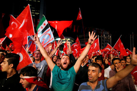 Pro-Erdogan supporters wave flags during a demonstration at Taksim Square on July 20, 2016 in Istanbul. Photo by Ammar Awad / Reuters