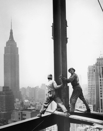 New York construction workers are seen with the Empire State Building in the background, 1950. Photo by Ben McCall / FPG / Hulton Archive / Getty Images