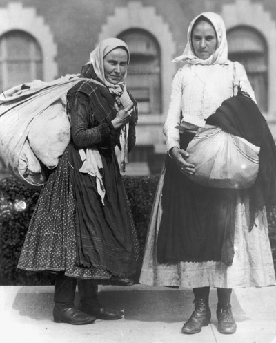 Two young Polish peasant women ready to leave Ellis Island, c. 1910. Photo by Getty