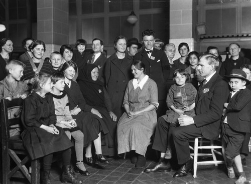 Immigrants at Ellis Island waiting around and passing the time, c. 1900. Photo by Getty